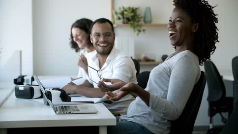 Joyful-colleagues-laughing-during-work